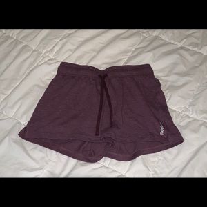 dark purple reebok cloth running shorts